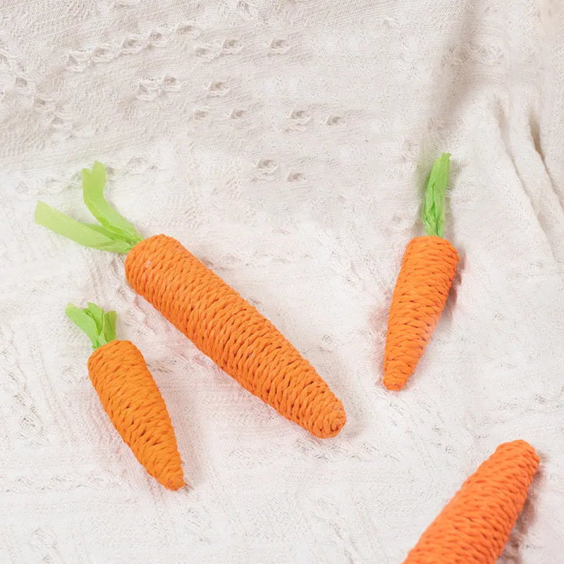 Set of four cat toys: ringing stones, paper carrots, batting sticks, and textured grinding sticks.