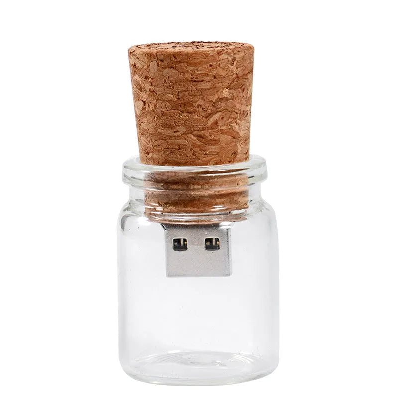Chocolate brown wooden USB flash drive shaped like a drift bottle with custom engraved lettering on the side