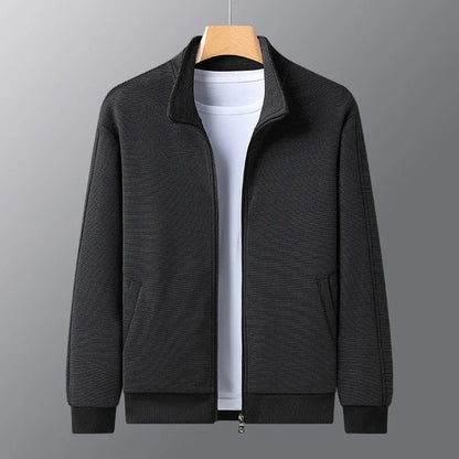 Man wearing a black casual zip-up jacket with a stand-up collar and athletic fit.