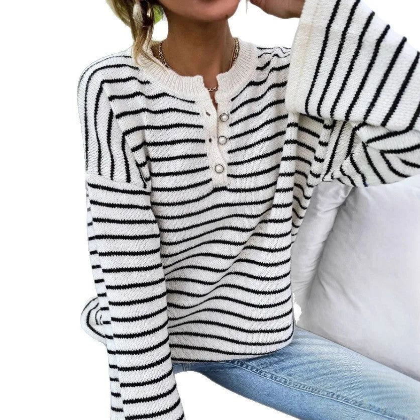 Black and white striped women's casual top with drop-shoulder sleeves and button detail