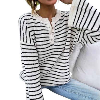 Black and white striped women's casual top with drop-shoulder sleeves and button detail