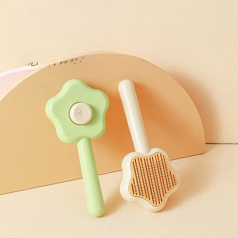 Green and yellow stainless steel self-cleaning cat comb for de-shedding, measuring 20cm.