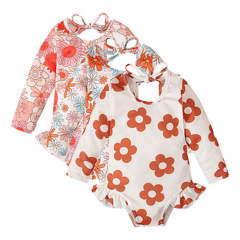 Girl's swimsuit with graphic flower print and crew neck open back design in breathable polyester fabric available in white orange and orange red colours in sizes 70 yards to 110 yards