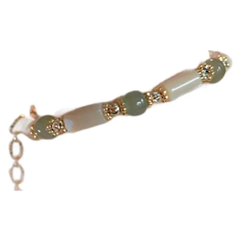 Hetian Jade white lip shell bracelet with geometric round beads on wrist
