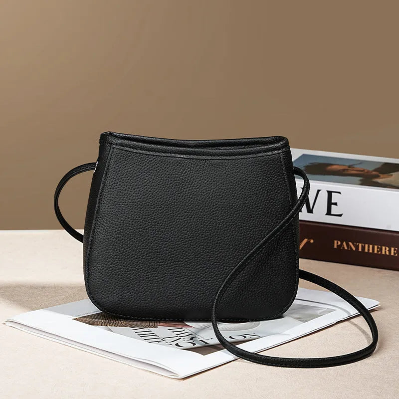 Women's genuine cowhide leather messenger bag showing organisational compartments and sandwich pockets in neutral colour
