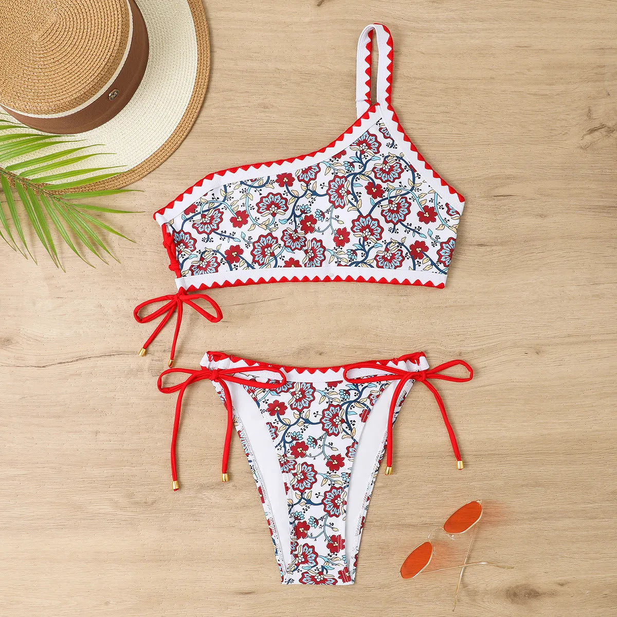 Blue one-shoulder bikini set with floral pattern on mannequin
