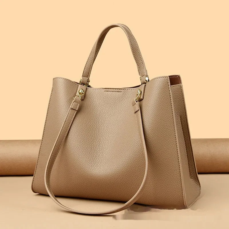 Women's messenger tote bag in horizontal square shape with crossbody strap and internal compartments