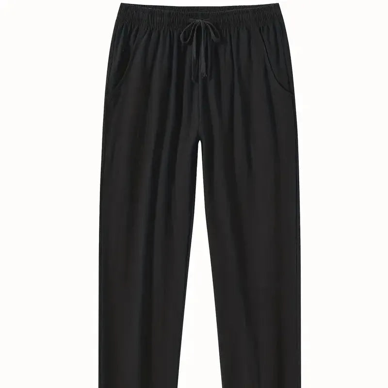 Man wearing loose-fitting cotton beach trousers in a solid colour, showcasing casual summer style.