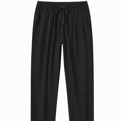 Man wearing loose-fitting cotton beach trousers in a solid colour, showcasing casual summer style.