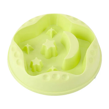 Blue slow feeder dog bowl with raised moon and star patterns inside, non-slip base
