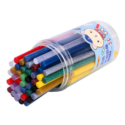 Pack of 55 clear hot melt glue sticks with 7.0mm diameter next to a glue gun