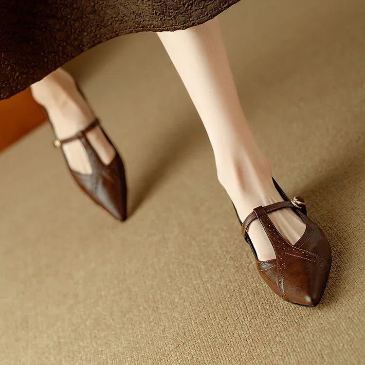 Brown women's pointed toe flat shoes with a round toe and metal detail on a casual cowhide upper.