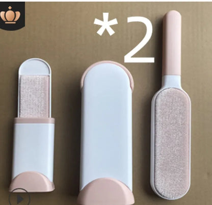 Blue reusable pet hair removal brush with double-sided head next to its self-cleaning base.