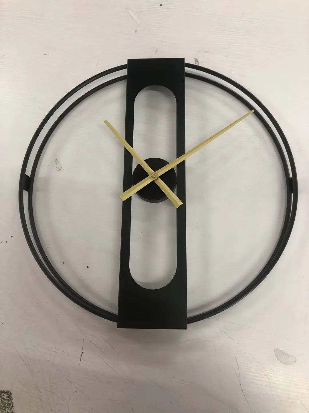 Large round metal wall clock with black finish showing analogue dial, 50cm in diameter.