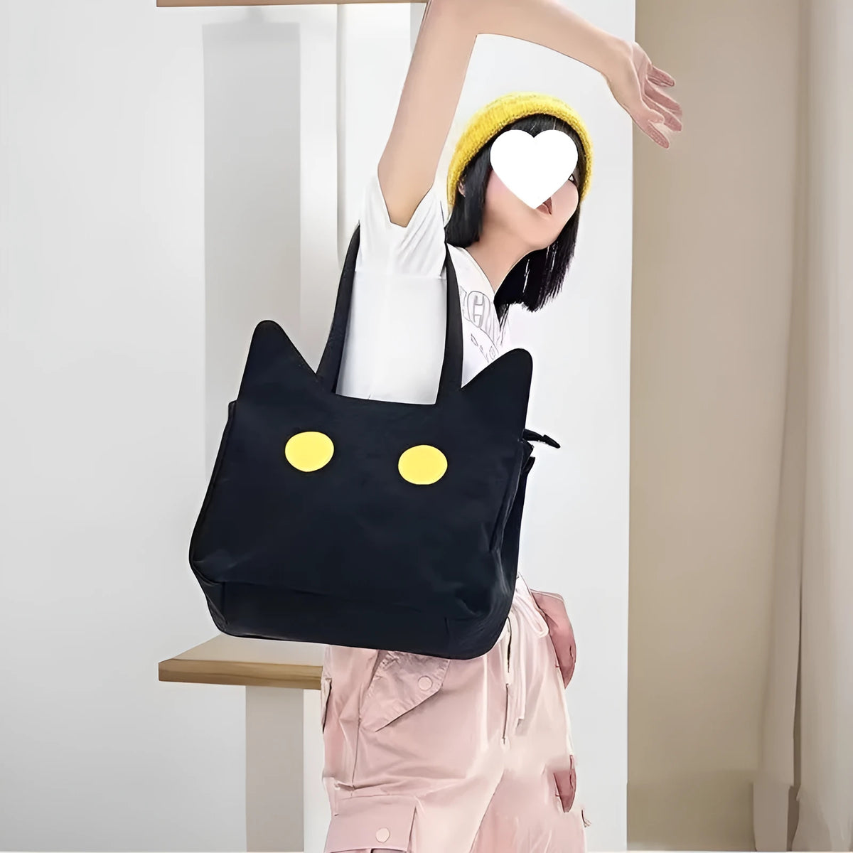 Black cat-shaped nylon tote bag with medium-soft structure, nylon lining, and sandwich zipper pocket, 34cm x 13cm x 27cm.