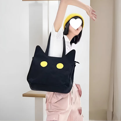 Black cat-shaped nylon tote bag with medium-soft structure, nylon lining, and sandwich zipper pocket, 34cm x 13cm x 27cm.