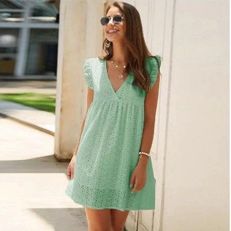 Chic cotton mini dress with floral embroidery and v-neck design for a romantic, summer-ready look