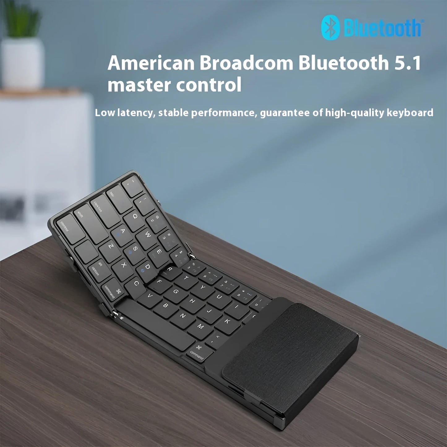 Black portable folding Bluetooth keyboard for tablets and mobile phones, shown folded.