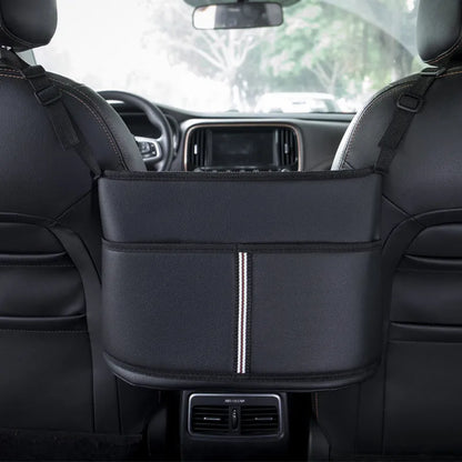 Black leather car seat gap storage bag hanging from armrest with tissue box, showing textured grain detail.