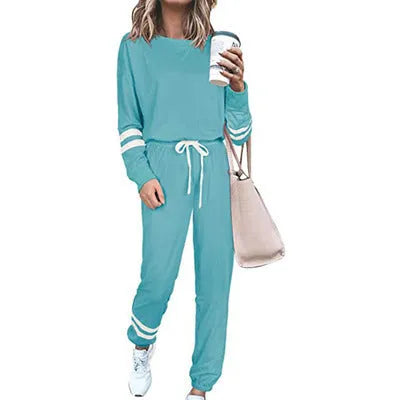 Women's loose-fitting plus size casual suit in a cotton blend, shown in a solid colour with a half-sleeve top and trousers.
