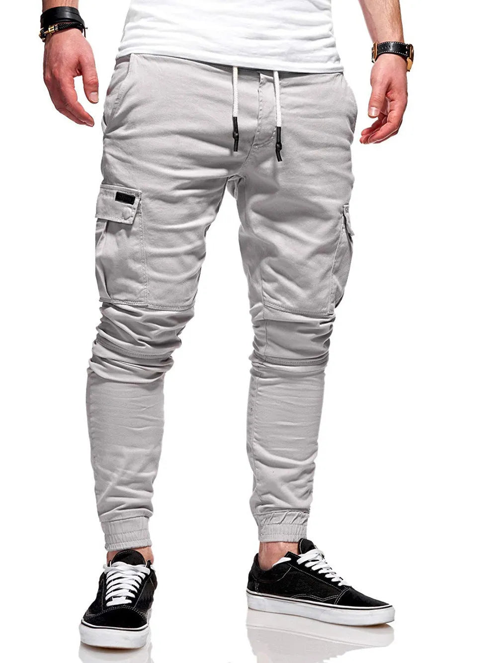 Men's light blue polyester loose-fit straight-leg trousers with dimensional patch pockets and elastic waistband laid flat.