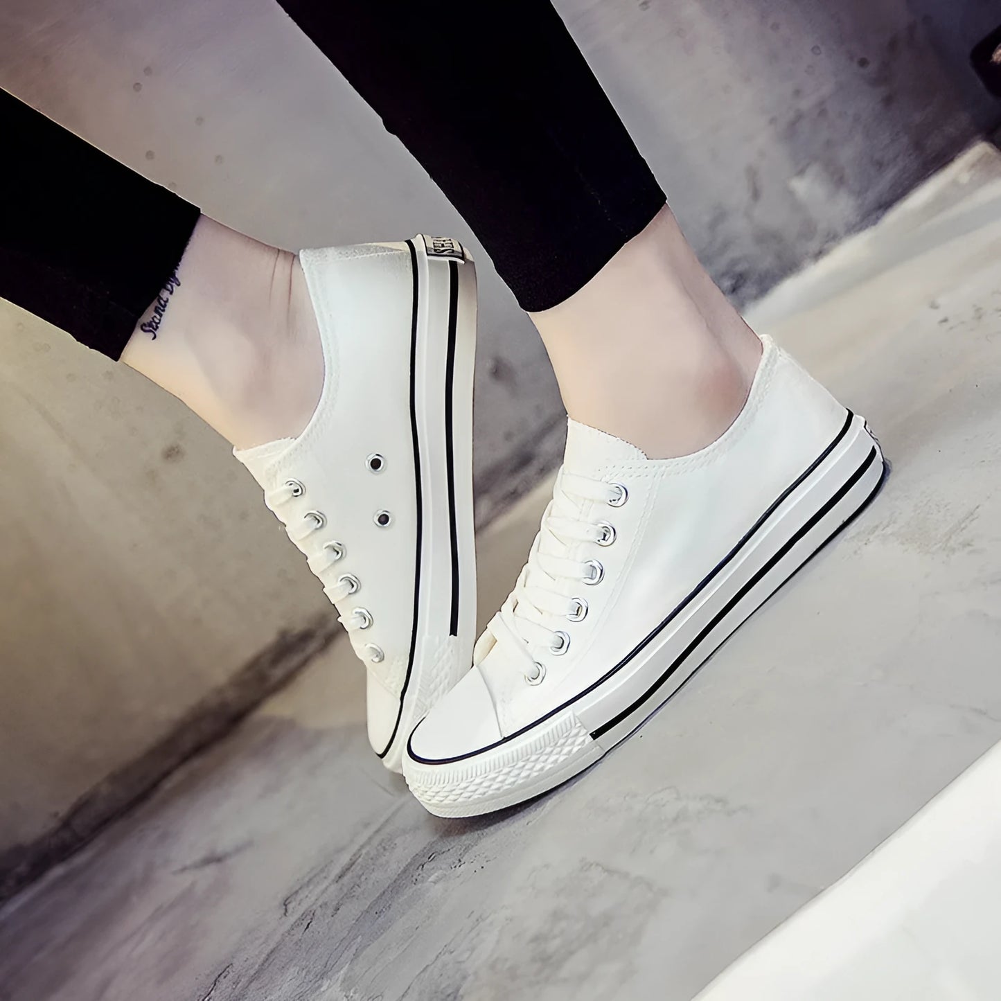 Women's solid-colour canvas casual shoes in black, shown from the side.
