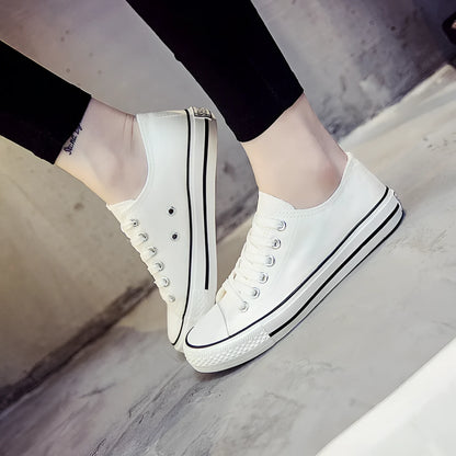 Women's solid-colour canvas casual shoes in black, shown from the side.