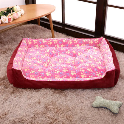 Beige plush pet bed for small dogs with a removable cover and non-slip base, shown in a home setting.
