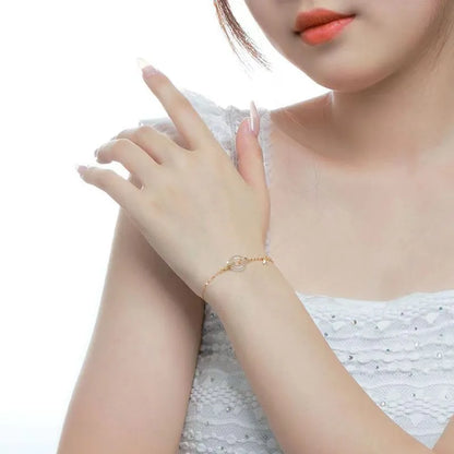 Women's silver and gold electroplated bracelet with peace buckle charm and white chalcedony stone.