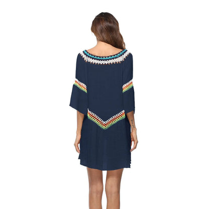 Crocheted white beach cover-up with open-knit design, worn over swimsuit, demonstrating UPF 50+ sun protection.