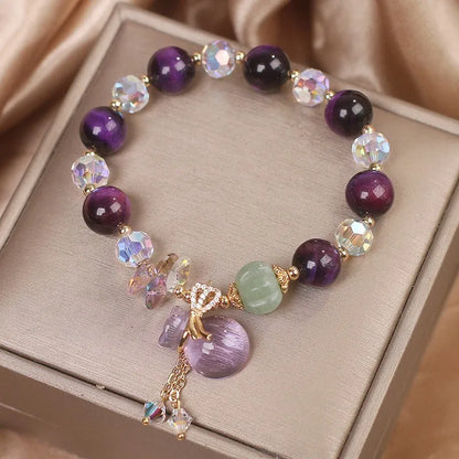 Women's crystal bracelet with purple tigereye money bag pendant and rhinestone decorations