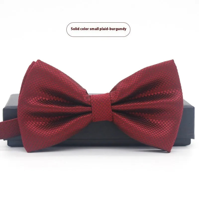 A solid colour pre-tied bow tie with an adjustable neck strap, shown in a classic flat head shape.