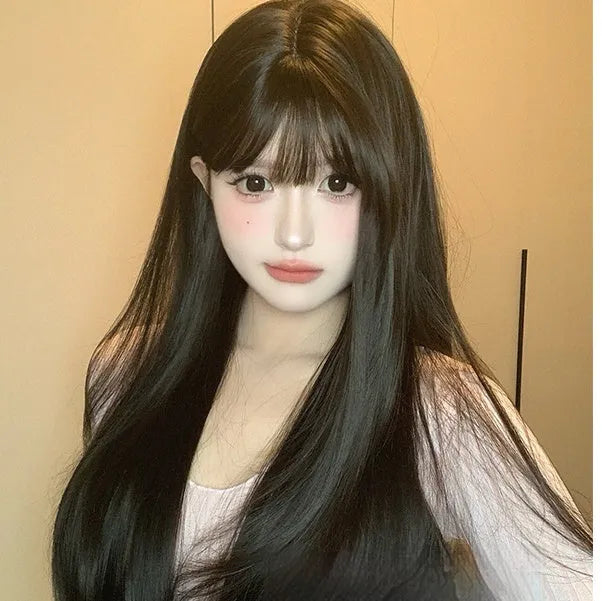 Dark brown long straight synthetic wig with fringe on a wig stand.