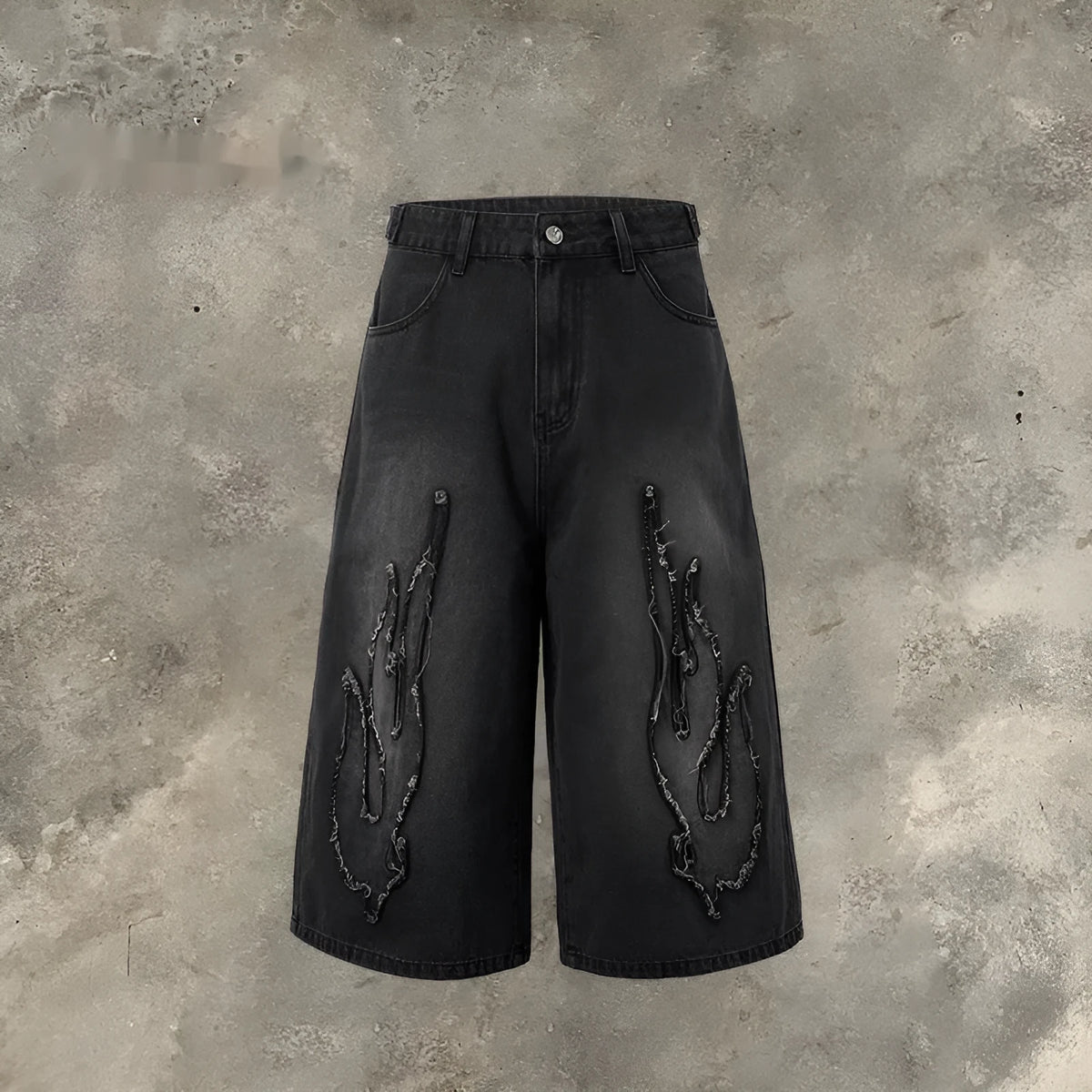 Men's black cropped denim shorts with a red and yellow flame embroidery patch on the leg.