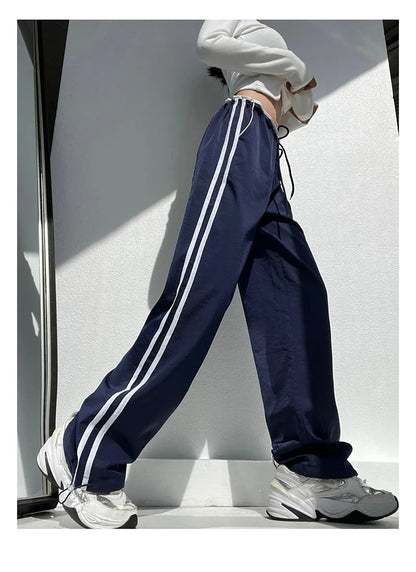 Women's navy blue straight-leg trousers with white contrast ribbon parallel bars pattern design