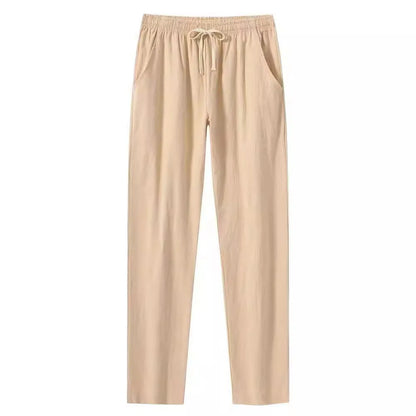 Man wearing loose-fitting cotton beach trousers in a solid colour, showcasing casual summer style.