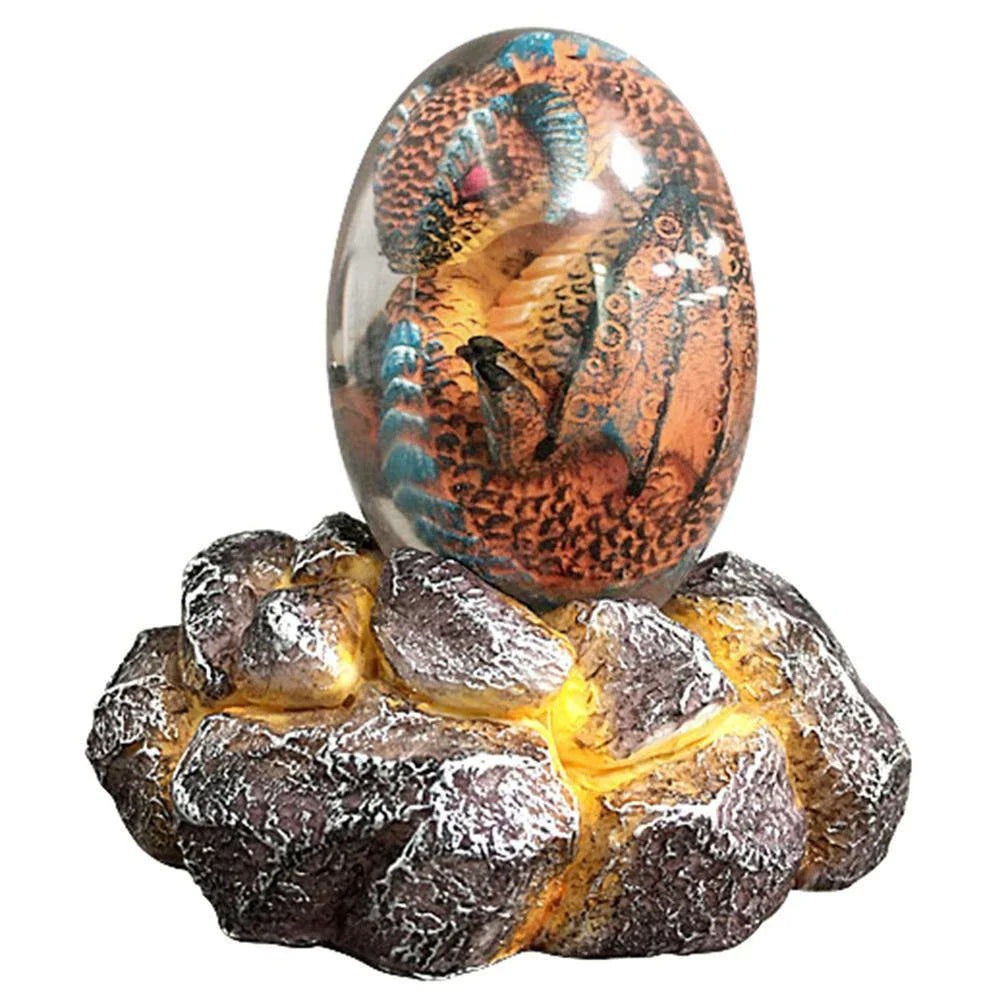 A lifelike resin dragon egg ornament with a crystal-clear, transparent design, sitting on a glowing lava-style base.