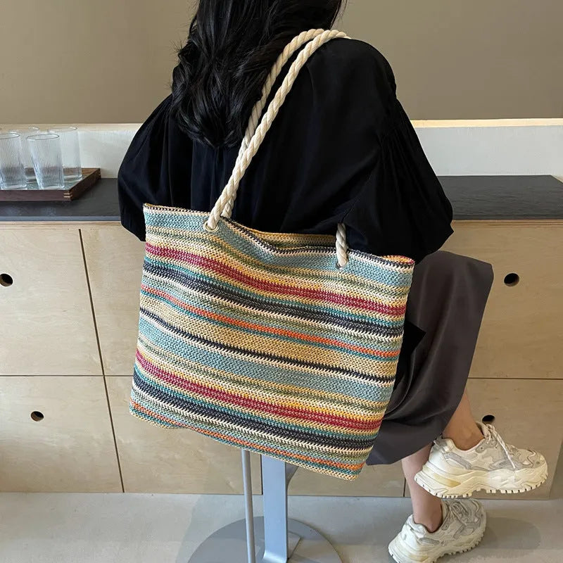 Straw woven large capacity shoulder bag crafted from durable nylon with polyester lining, featuring classic woven pattern design in blue colour with convenient single shoulder strap carrying