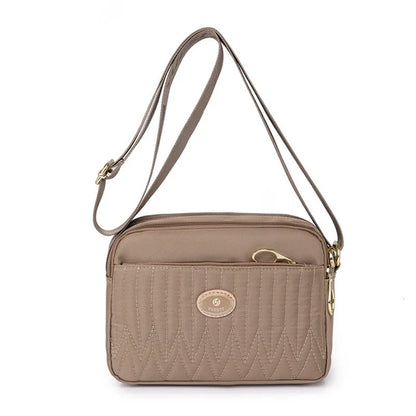 Compact nylon messenger bag for women in various colours with adjustable strap