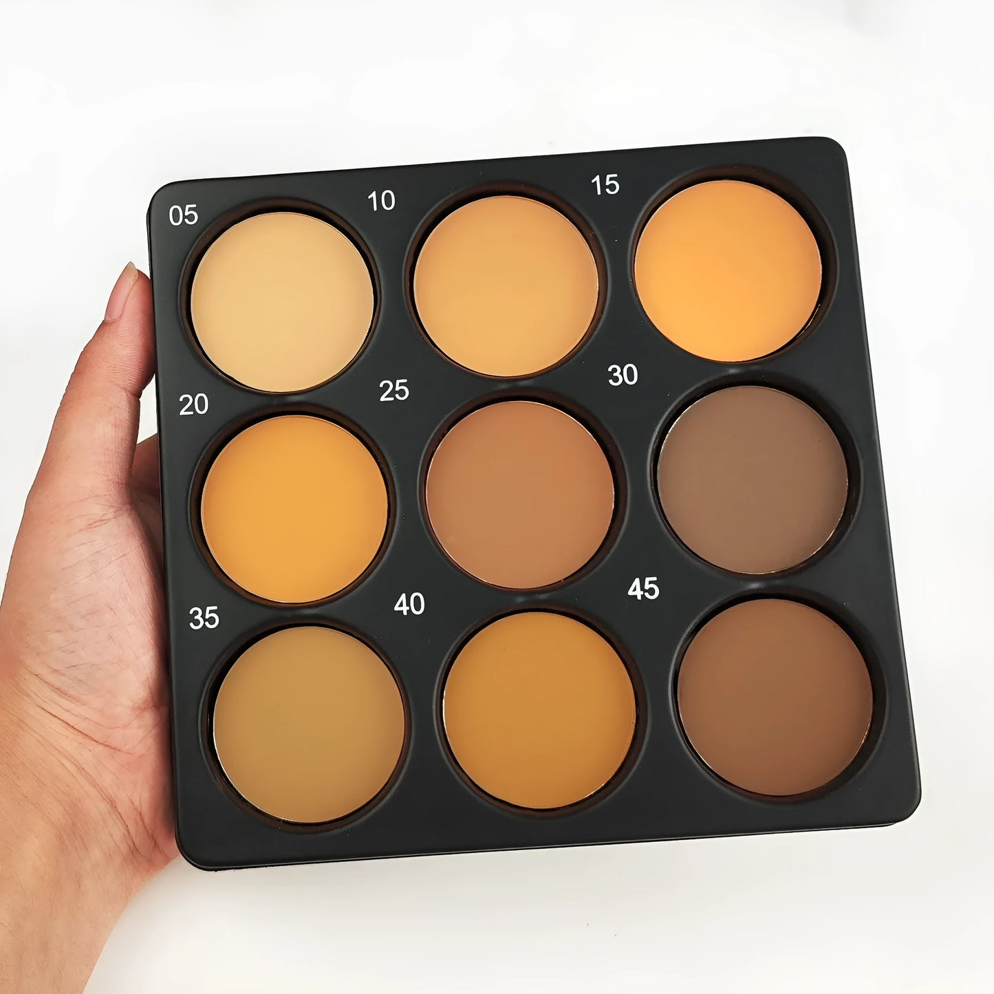 Dark matte makeup palette showing nine waterproof colours with repair disk
