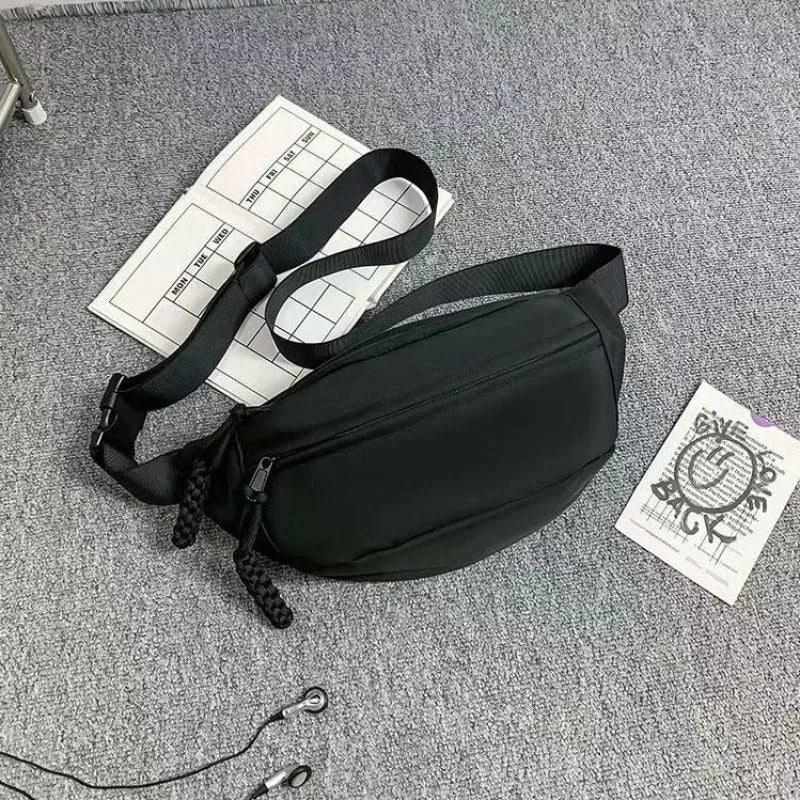 Men's small black polyester crossbody chest bag with adjustable strap.