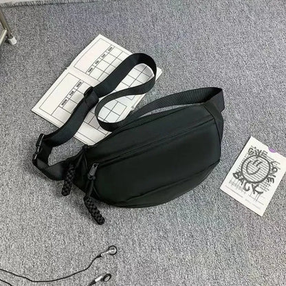 Men's small black polyester crossbody chest bag with adjustable strap.