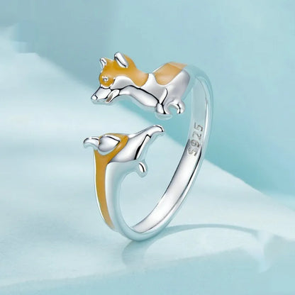 Close-up of an adjustable silver-toned ring with a detailed cartoon corgi dog design.