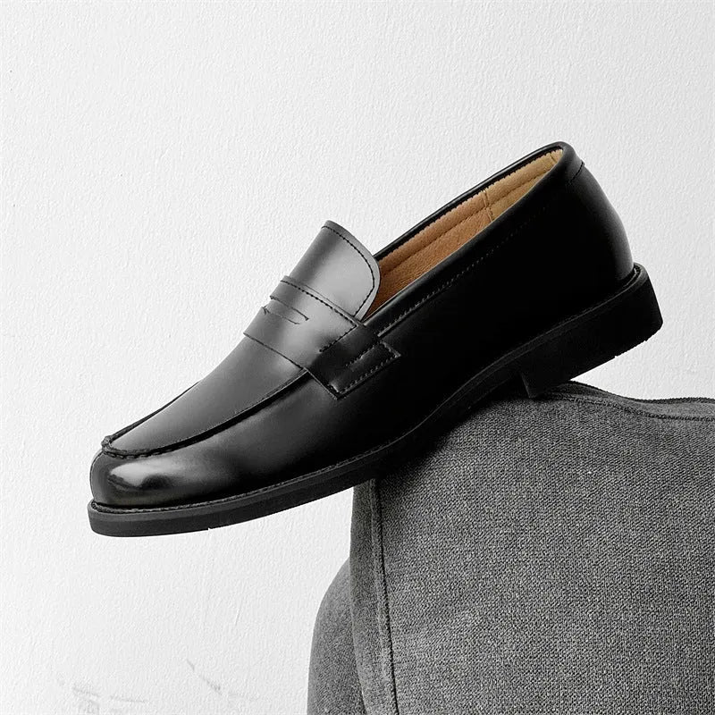 Classic black slip-on Derby leather shoes for men and women on a plain background
