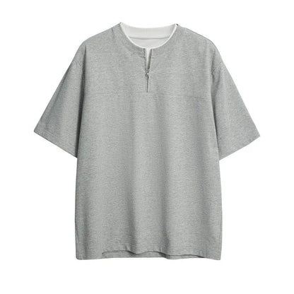 Solid colour loose fit cotton blend pullover top with patchwork collage detailing on a model.