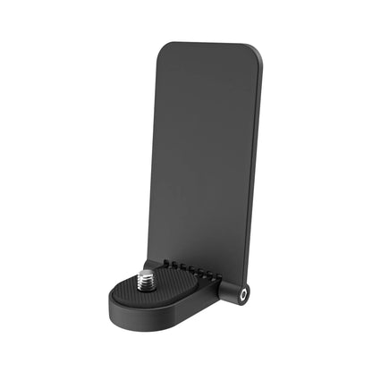Black magnetic bracket base and handle accessory for an Insta360 X4 camera on a desktop.