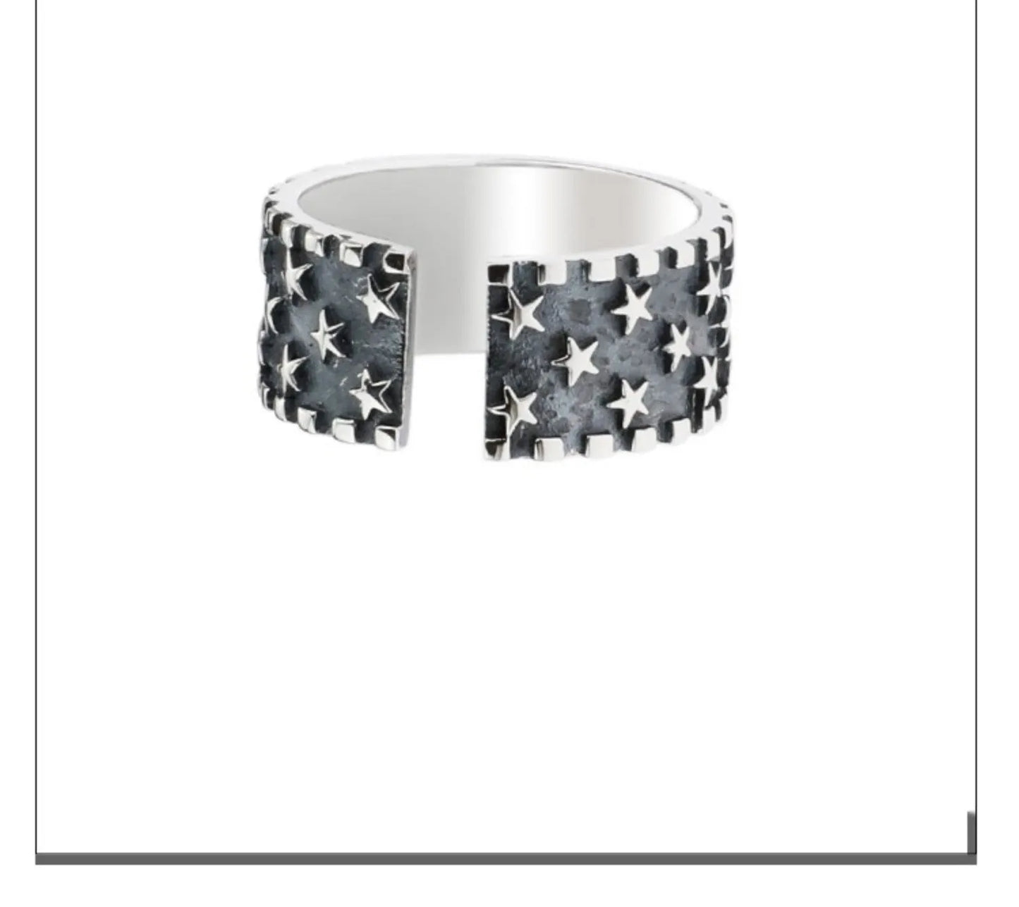 Adjustable opening sterling silver ring with etched five-pointed star geometry pattern on a band.