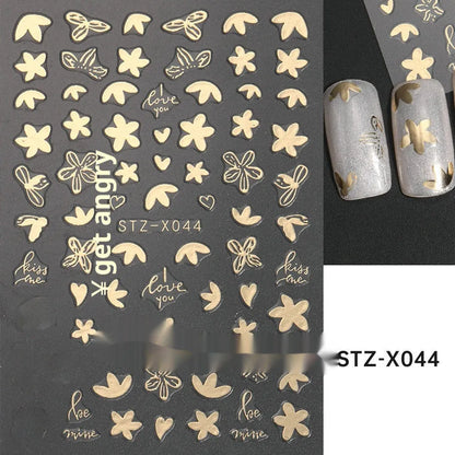 Assortment of black and silver nail sticker designs including cartoon and French tip patterns on a plastic sheet.