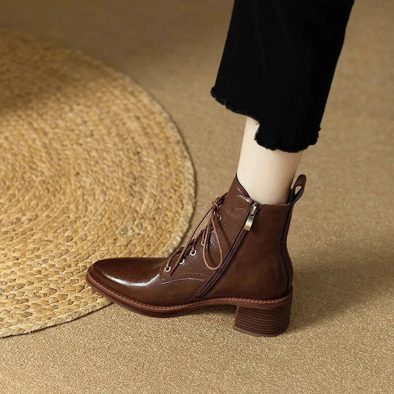 Women's black pointed toe short tube boots with a 5.5cm heel on a white background.