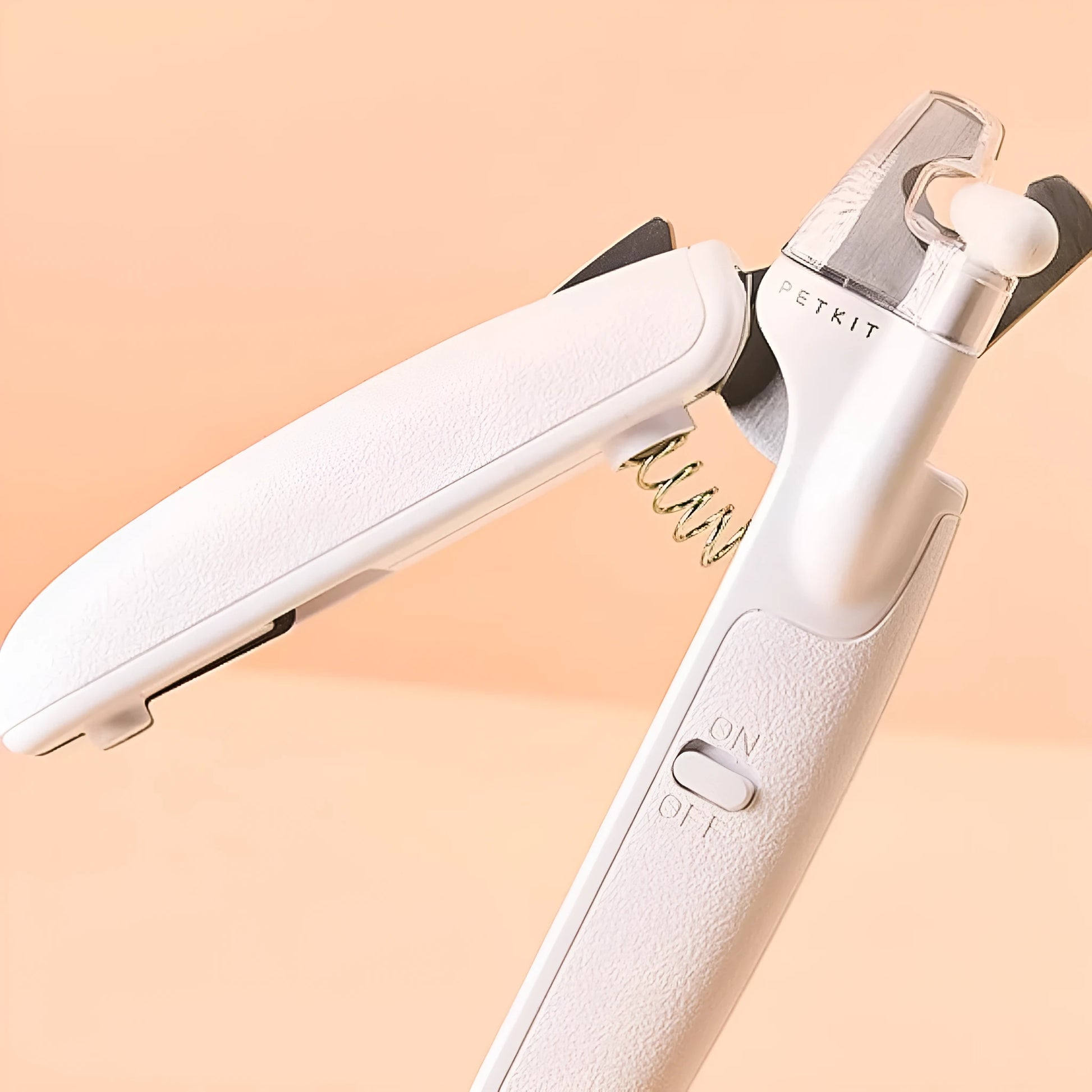 White LED pet nail clippers with a transparent safety guard and a nail file on a grey background.
